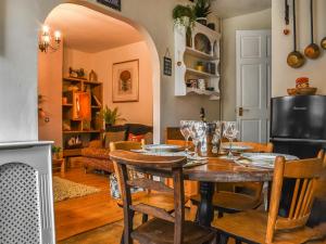 a dining room with a table and chairs at Half Pint Cottage in Haworth