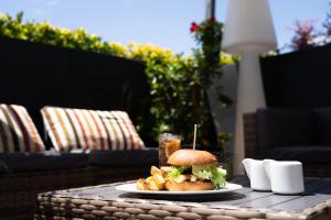 a plate with a sandwich and fries on a table at Warmthotel in Rome