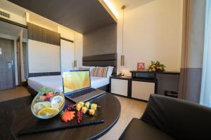 a hotel room with a table with a laptop on it at Warmthotel in Rome