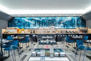 a restaurant with blue chairs and tables and a bar at Warmthotel in Rome