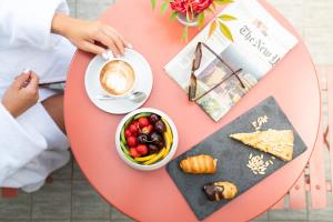 a table with a cup of coffee and a plate of food at Warmthotel in Rome