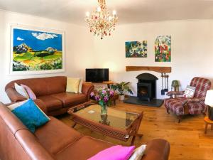 a living room with a couch and a fireplace at Smithy Cottage in Middle Mill