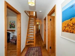 a staircase in a house with a painting on the wall at Smithy Cottage in Middle Mill