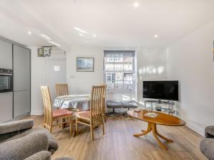 a living room with a bed and a table and a couch at Two Little Ducks in Wells next the Sea