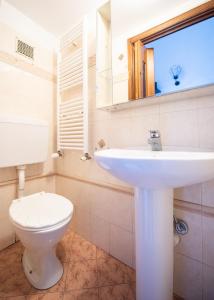 a bathroom with a white toilet and a sink at Modern and serviced apartment in Turin