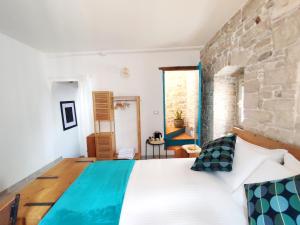 a bedroom with a large bed with a stone wall at B&B Palazzina Verde Stella in Palo del Colle