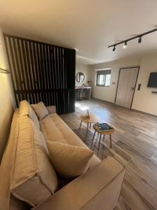 a living room with a couch and a table at Χenion Inn - Athens Airport, Easy Check In Anytime in Markopoulo