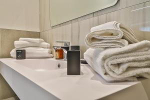 a bathroom with a sink and towels on a counter at BeB Luxury Rooms in Castelfranco Emilia