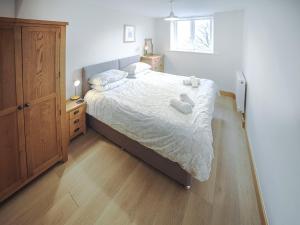 a bedroom with a bed with two towels on it at Borrowdale View - Uk45176 in Threlkeld