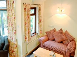 a living room with a couch and a window at Bank End in Glenridding