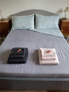a bed with two towels sitting on top of it at Casa Morena in Rapallo