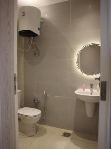 a bathroom with a toilet and a sink at White House furnished appartments for rent in 6th Of October