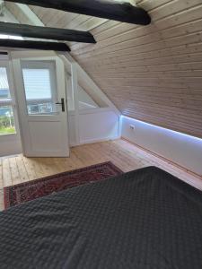 a room with a bed and a door and a window at Alte Schmiede in Oldenburg