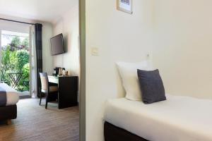 Postel nebo postele na pokoji v ubytování SOWELL HOTELS Domaine de la Petite Isle