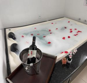 a bottle of wine in a bucket in a bath tub at Hotel Yoguedes in Padre Paraíso +28 photos