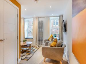 a living room with a couch and a table at Town Square House - Uk45610 in Alnwick