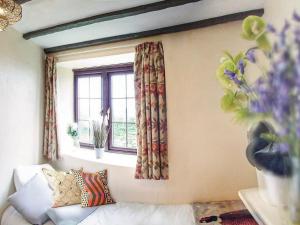 a living room with a couch and a window at Sage Cottage in Truro