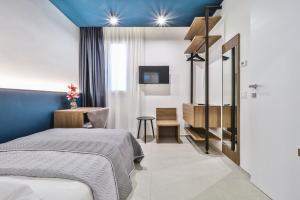 a bedroom with a bed and a desk and a tv at BeB Luxury Rooms in Castelfranco Emilia +67 photos