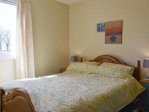 a bedroom with a bed and a window at Hillside in Kilkhampton