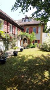a large house with red shutters on a yard at Swiss Art & Vine Pop-Up House in Biel