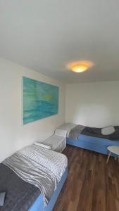 a room with two beds and a table in it at Swiss Art & Vine Pop-Up House in Biel +19 photos