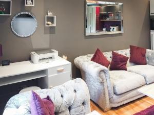 a living room with a couch and a mirror at The Inn And Around in Kenton