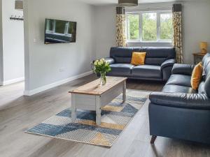 a living room with a couch and a coffee table at Rose Lodge - Uk40019 in Halwill
