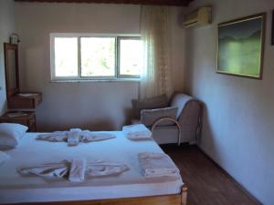 a room with a bed and a couch and a window at Dalyan Pension in Dalyan