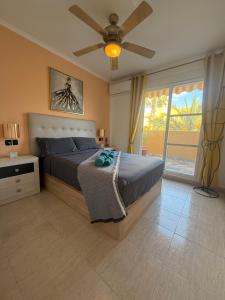 a bedroom with a bed and a ceiling fan at CASA EVA Naturista, Vera Playa in Playas de Vera +39 photos