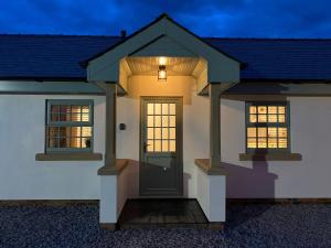 a house with a front door at night at Pointer Cottage in Preesall