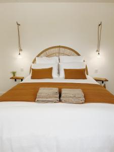a white bed with two folded towels on it at Maison La Julianne in Callas +30 photos