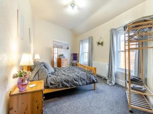 a bedroom with a bed and a bunk bed ladder at The Flat in Whitchurch