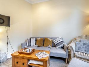 a living room with a couch and a coffee table at The Flat in Whitchurch