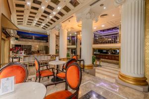 a restaurant with tables and chairs and a bar at Tilia Hotel in Istanbul