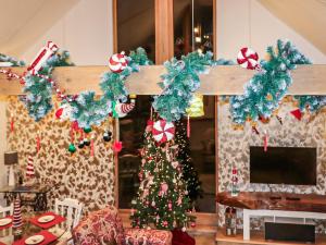 a cross with christmas wreaths on it at Blackberry Barn in Maidstone