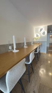 a long wooden table with chairs in a room at Ponti Beach Hotel in Vasiliki