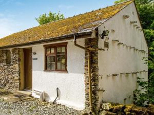 a small white house with a window at Borrowdale View - Uk45176 in Threlkeld