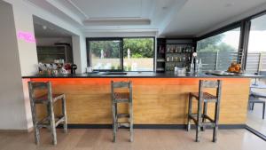 a bar with two stools at a wooden counter at Ponti Beach Hotel in Vasiliki