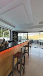a bar with chairs and a counter with a view at Ponti Beach Hotel in Vasiliki