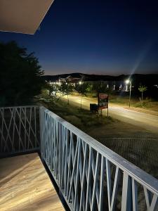 a balcony with a night view of a street at Nobus Jezerska zvezda A7 in Veliko Gradište