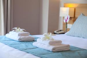 
two towels on a bed in a hotel room at Louis St. Elias Resort & Waterpark in Protaras
