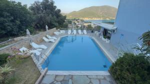 a swimming pool with lounge chairs and a hotel at Ponti Beach Hotel in Vasiliki