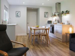 a kitchen and dining room with a table and chairs at Gwynant Lodge - Uk47608 in Caernarfon