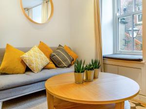 a living room with a couch and a table at Town Square House - Uk45610 in Alnwick