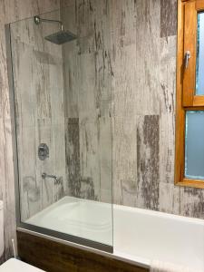 a bathroom with a shower with a glass door at Orn, Chill Out Houses By A.M.A in San Carlos de Bariloche +40 photos