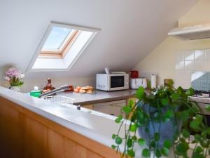 a kitchen with a sink and a microwave at Lavrean Farm in St Austell