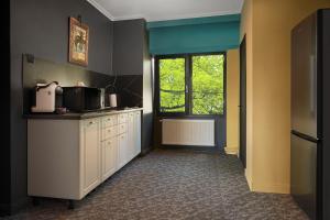 a kitchen with white cabinets and a window at Lapusneanu Central Apartments in Iaşi