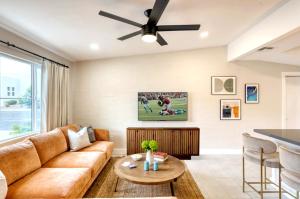 a living room with a couch and a ceiling fan at Brilliance-Fire Pit & Foosball-Middle of Old Town in Scottsdale