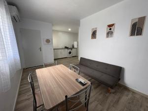 a living room with a table and a couch at Casa Nova de Bolonia in Bolonia