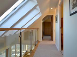 a staircase in a house with a skylight at Rowan House in Fiskavaig